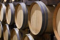 Giving the wine time to mature. Closeup of wine barrels in a wine distillery.