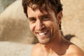 Giving you a relaxed smile. Cropped portrait of a handsome man smiling while at the beach. Royalty Free Stock Photo