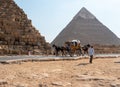 Giza, Cairo, Egypt - September 30, 2021: Pyramids of Giza, a complex of ancient monuments on the Giza plateau. Egyptians ride