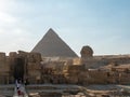 Giza, Cairo, Egypt - September 30, 2021: View of the Sphinx statue and the Egyptian pyramid on the Giza plateau. Tourists go Royalty Free Stock Photo