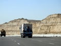 Giza, Egypt, January 26 2023: A big truck loaded with large blocks of stone, limestone, rocks taken from quarries in mountains