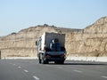 Giza, Egypt, January 26 2023: A big truck loaded with large blocks of stone, limestone, rocks taken from quarries in mountains