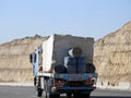 Giza, Egypt, January 26 2023: A big truck loaded with large blocks of stone, limestone, rocks taken from quarries in mountains