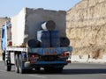 Giza, Egypt, January 26 2023: A big truck loaded with large blocks of stone, limestone, rocks taken from quarries in mountains