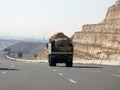 Giza, Egypt, January 26 2023: A big truck loaded with large blocks of stone, limestone, rocks taken from quarries in mountains