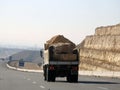 Giza, Egypt, January 26 2023: A big truck loaded with large blocks of stone, limestone, rocks taken from quarries in mountains