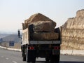 Giza, Egypt, January 26 2023: A big truck loaded with large blocks of stone, limestone, rocks taken from quarries in mountains