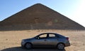 KIA Cerato car in front of The red north pyramid of Dahshur of king Sneferu, named for the rusty