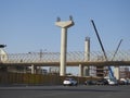 Giza Egyptian overhead transportation system monorail construction site with concrete and steel columns and cranes