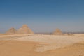 The Giza pyramid complex, an archaeological site on the Giza Plateau, on the outskirts of Cairo, Egypt. It includes the three Royalty Free Stock Photo