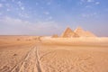 Giza Pyramids and a chariot track through the sand of desert