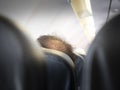 Glabrous man head on aircraft seat. Hidden camera view from back seat. bald head thin and scalp and broken hair. concept healthcar Royalty Free Stock Photo