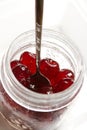 Glace cherries ingredients in a vintage jar on white Royalty Free Stock Photo
