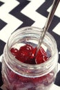 Glace cherries in a vintage jar overhead Royalty Free Stock Photo