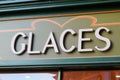 Glaces french text means ice cream sign facade store front of wall shop