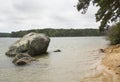 Glacial erratic on shore of Cliff Pond at Cape Cod Royalty Free Stock Photo