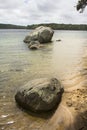 Glacial erratic on shore of Cliff Pond at Cape Cod Royalty Free Stock Photo