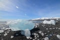 Glacial ice on the shore of a black sand beach Royalty Free Stock Photo