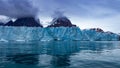 Glacier of a blue color on a very calm and smooth Greenland sea Royalty Free Stock Photo