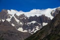 A hanging Glacier, peeking out over the forest, at the top of one of the mountains of the French Valley in Torres Del Paine Natio Royalty Free Stock Photo