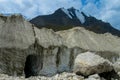 Glacier cracks and ice covered with gray morena stones Royalty Free Stock Photo