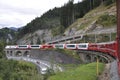 The glacier Express train is driving across the swiss alps