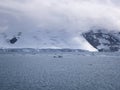 Glacier And Low Clouds Covering The Coastline Of Paradise Bay