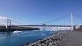 Riverside Bridge And Floating Blue Iceberg On The River