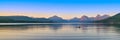 Glacier National Park, Montana United States - July 31, 2023: Young woman on a paddleboard at dusk on Lake McDonald near Apgar