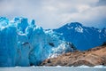 The glacier stands on the slope of the stone shore. Shevelev. Royalty Free Stock Photo