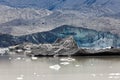 Glacier tongue calfing icebergs into glacial lake