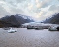 Glacier tongue slides from the Vatnajokull icecap or Vatna Glacier near subglacial Oraefajokull volcano, Iceland. Glacial lagoon