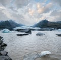 Glacier tongue slides from Vatnajokull icecap or Vatna Glacier near subglacial Oraefajokull volcano, Iceland. Glacial lagoon with