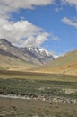 Glacier view in between dry mountains in Darcha-Padum road with clouds in sky during summer