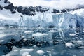 Shelf ice and ice floes reflecting in blue sea water, beautiful Paradise Bay, Antarctica