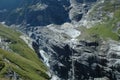 Glacier and waterfall in valley nearby Grindelwald in Alps.