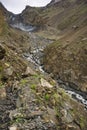 The glaciers covered by the old volcanic rock descend to the edge of Shimshal village, bringing with them the water Royalty Free Stock Photo