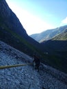 glaciers while tracking between mountains crossing with the help of rope