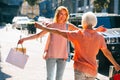 Woman and her mother meeting in the street stock photo