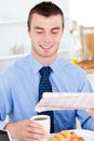 Glad businessman reading newspaper drinking coffee Royalty Free Stock Photo