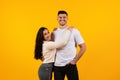 Glad cheerful young pretty arabic wife hugging tall husband, looking at camera, enjoy tender moment Royalty Free Stock Photo