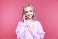 Glad cute young woman talking phone and smiling . Royalty Free Stock Photo
