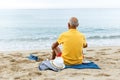 Glad man resting. Clothes on the sand near sea Royalty Free Stock Photo