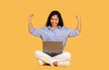 Glad excited latin young brunette woman winner in casual make fist up gesture, look at laptop, celebrate win Royalty Free Stock Photo