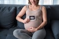 Joyful pregnant woman showing ultrasound photo of her baby Royalty Free Stock Photo