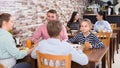 Glad family with teenagers having lunch