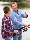 Father and son fishing on river Royalty Free Stock Photo