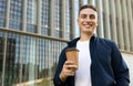 Glad handsome millennial caucasian man student manager enjoy coffee break with cup of drink