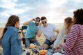 Glad happy millennial european and arab friends in sunglasses have fun enjoy free time with beer bottles