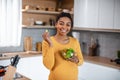 Glad hungry pretty millennial pregnant african american woman with belly eating salad from vegetables
